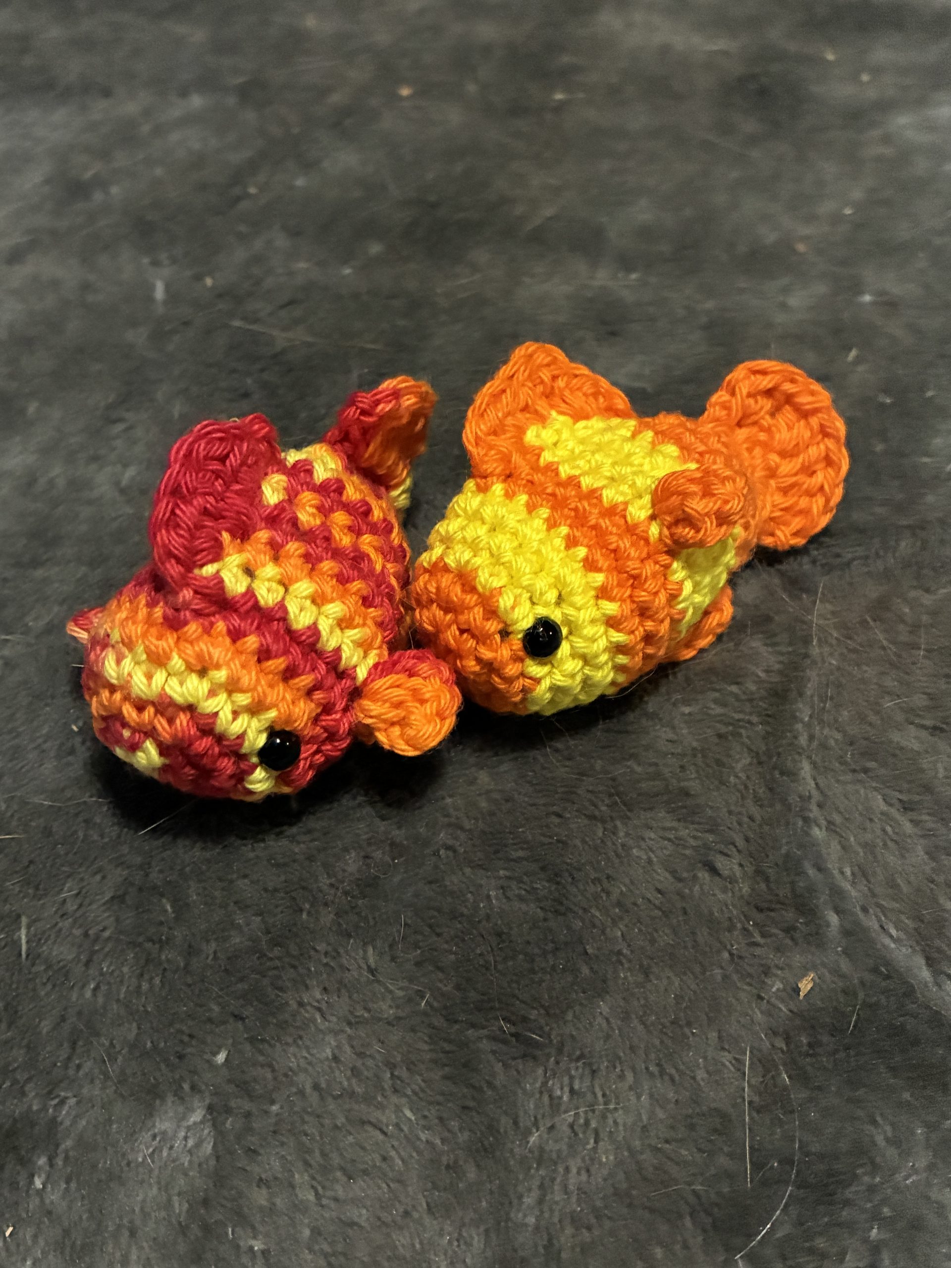 Pair of orange and yellow crochet goldfish